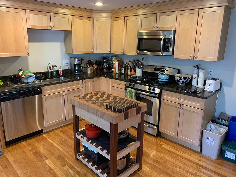 Open kitchen area with all stainless steel appliances. Dining nook off to the side. Half bath on first floor off kitchen.