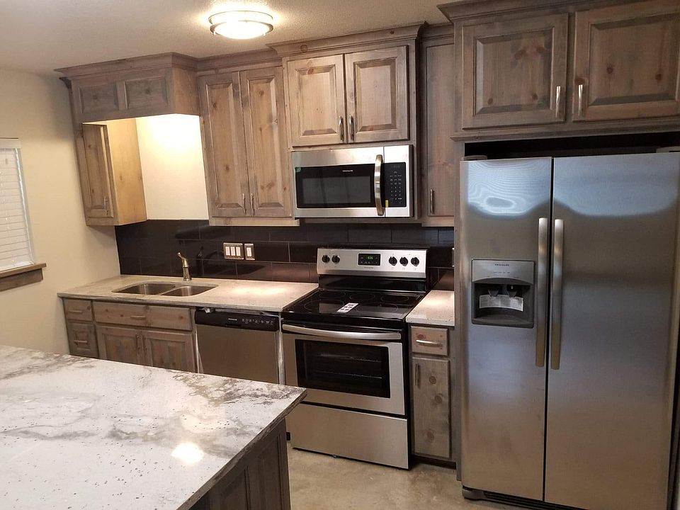 Kitchen includes all appliances, large island serves as food preparation area and/or as a table, includes padded barstools