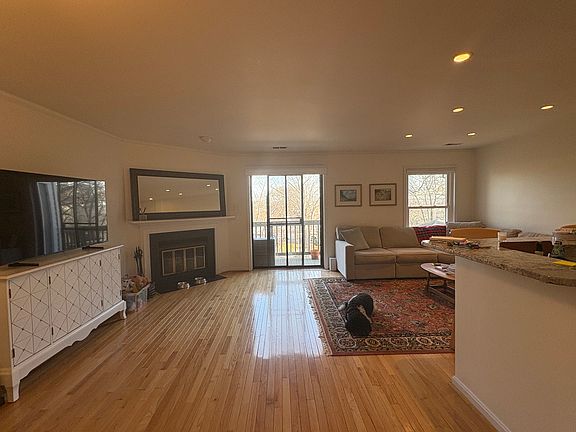 Main level: living room with woodburning fireplace. Amazing views, eastern light, and privacy.