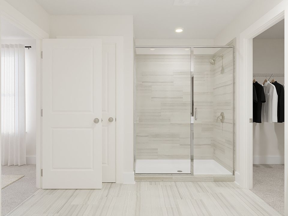 The primary bathroom offers dual vanity sinks and a walk-in shower.