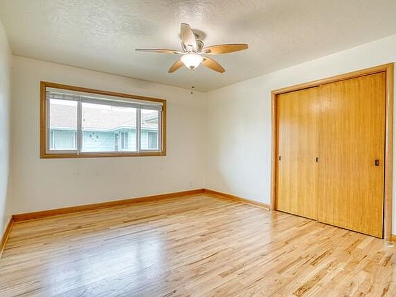Bedroom 2 - furnished with bed, side table, and lamp