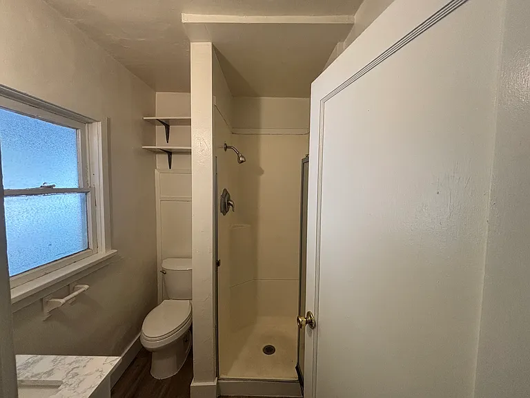 New bath sink and vanity, tiled shower and new flooring