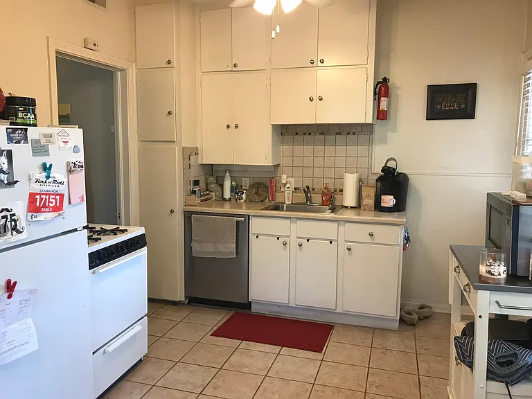 The stove and refrigerator have been replaced with new stainless GE range and refrigerator. All cabinets and walls have been repainted gray.