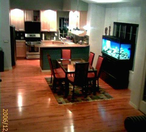 Open floor plan with maple hardwood floors and wood blinds. 