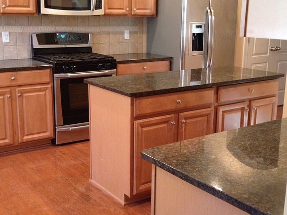 Kitchen boasts stainless-steel appliances, granite counters