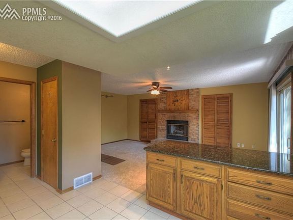 Kitchen looking in to family room w/fireplace