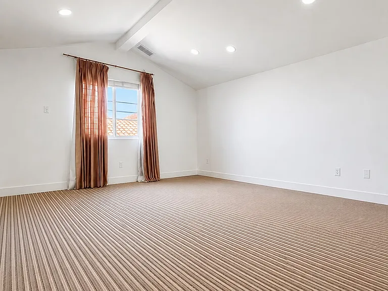 Second view of the massive top-floor entertainment room with abundant flexible living space