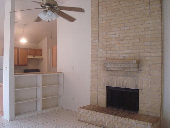 Living room with wood burning fireplace.