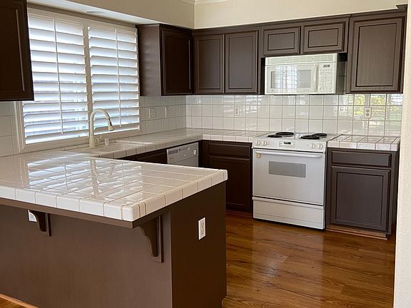 Newly painted cabinets. Electric stove and microwave are updated to slate (not as shown in picture).