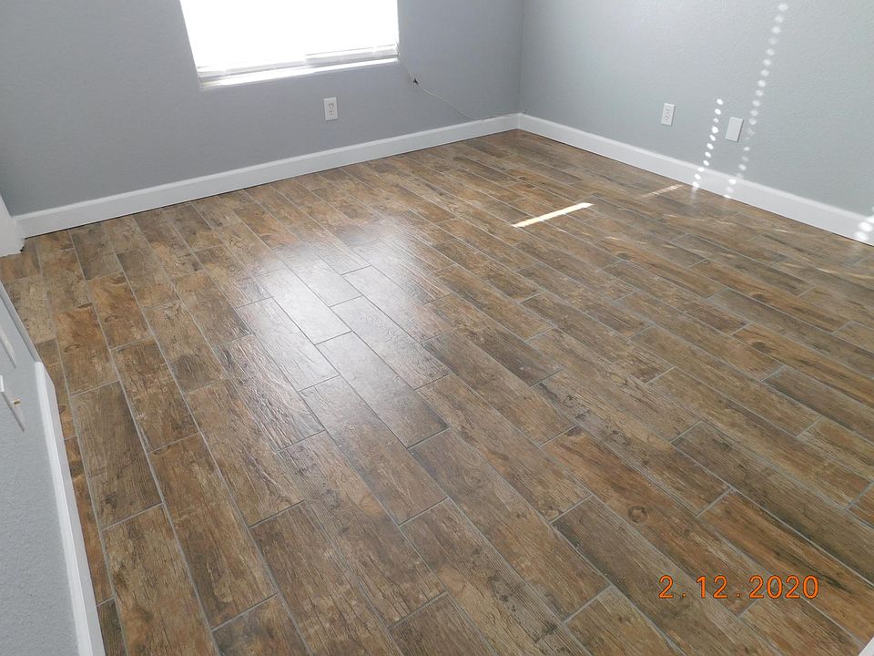 Master Bedroom completely renovated with new faux window blinds, ceiling fan, new porcelain plank tile flooring and new baseboard