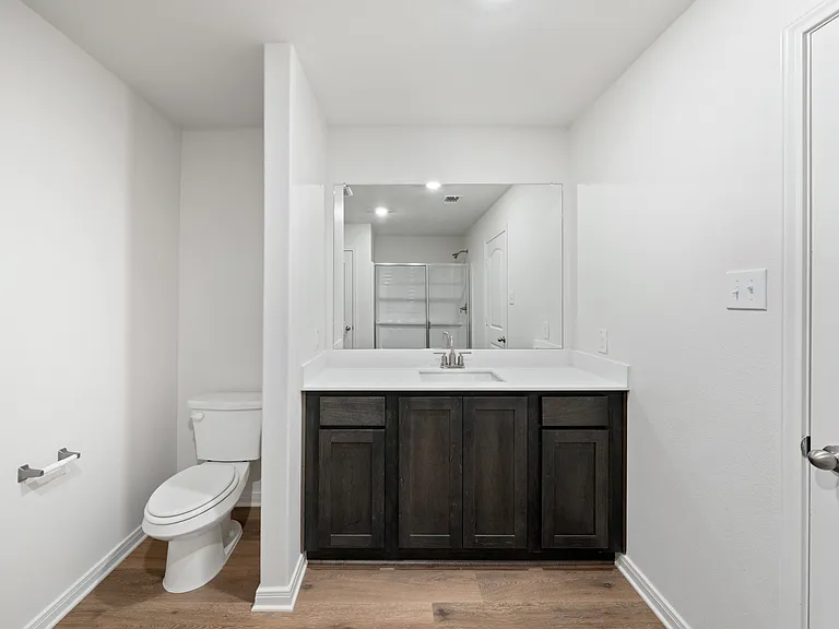 The master bathroom has a spacious vanity space.