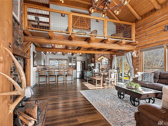 Stunning entry to this recently renovated log home. Modern updates have been successfully married with many of the original features, including the antler door handle and wagon wheel chandelier, that retain the character of the home.
