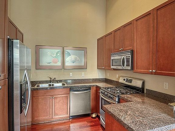 The kitchen features stainless appliances, granite counters and designer cabinets.