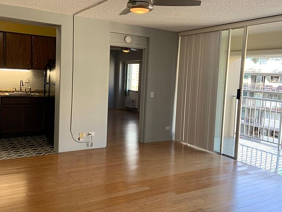 Living room facing kitchen and bedroom entrance