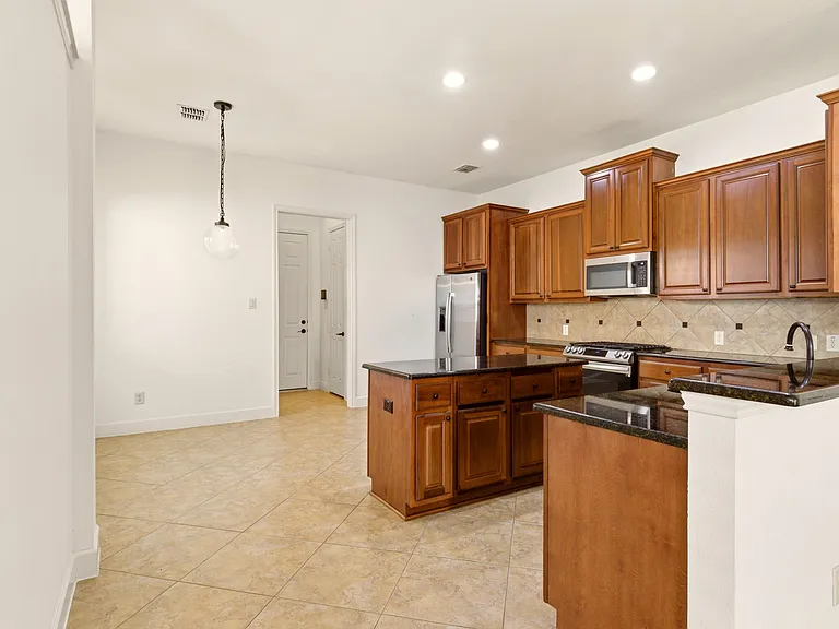 Open kitchen includes refridgerator
