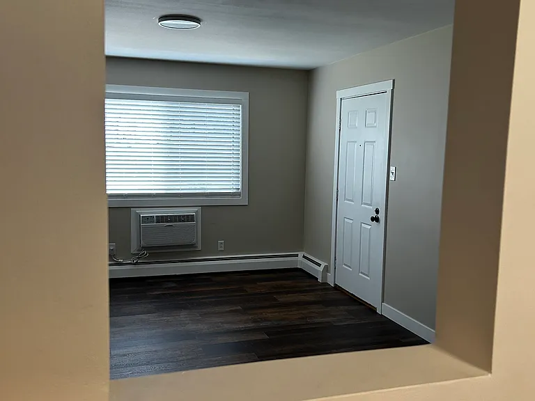 View of front door from sink/stove - Pre tile installation.