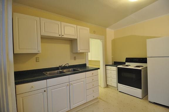 Large kitchen has room for a dining table in the opposite corner (behind the photographer).
