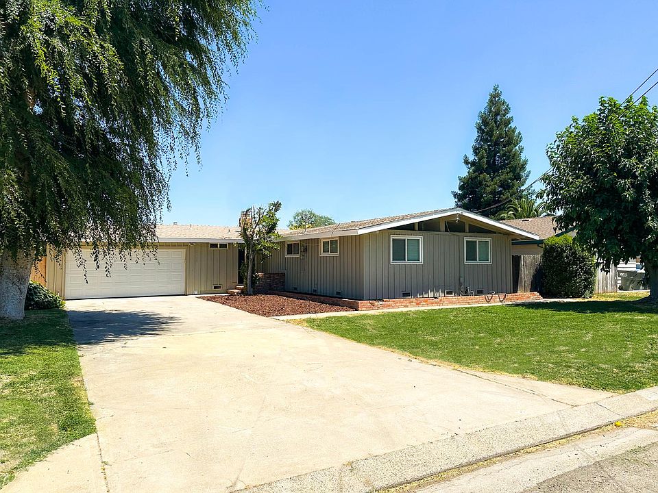 Extra Long driveway and large front yard with mature trees