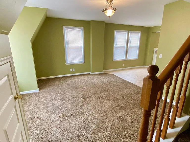 Family room with stairs leading to 3rd floor.