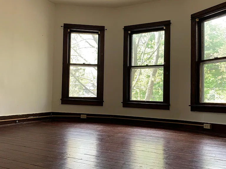 large primary bedroom with bay windows