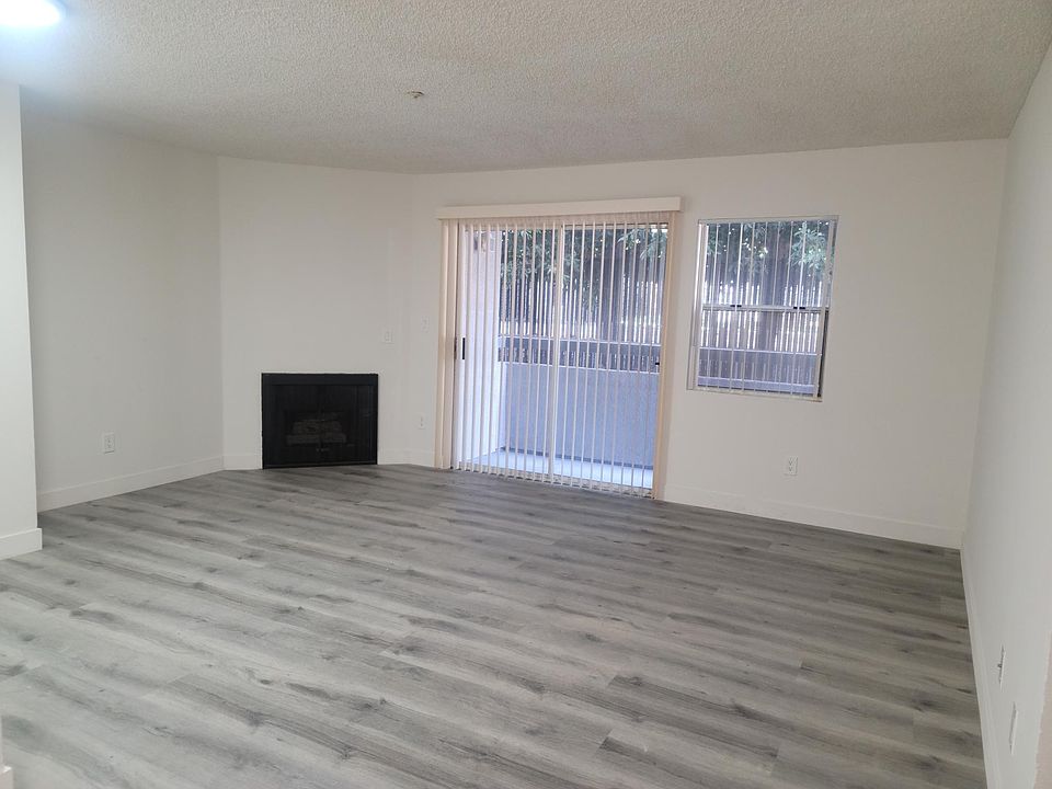 LIVING ROOM WITH FIREPLACE AND PRIVATE BALCONY