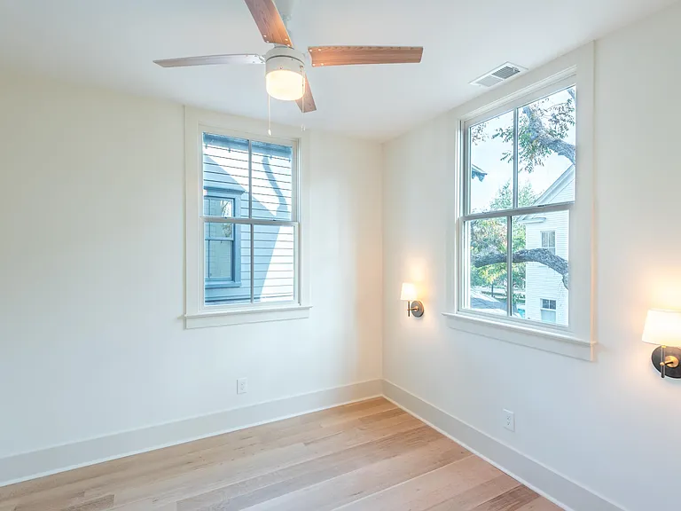 Each bedroom comfortably fits a queen bed positioned between the wall sconces. New windows throughout the house provide great insulation.