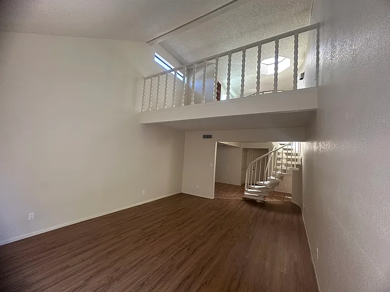 living room, spiral staircase & loft view from patio sliding door