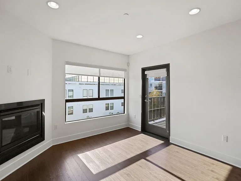 Living Room with Electric Fireplace, Recessed Lighting, Vinyl Flooring, and Patio