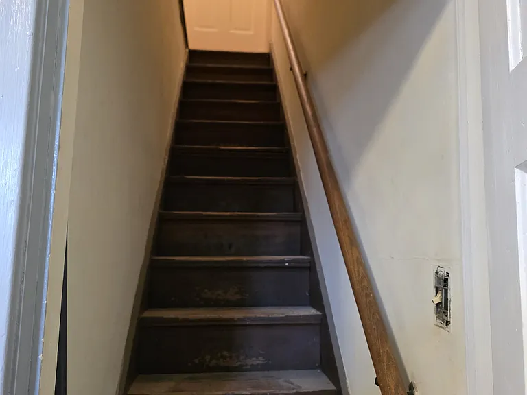 Looking up the back stairwell from the kitchen.