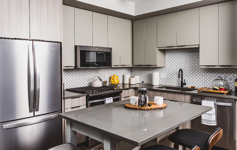 Kitchen featuring stainless-steel appliances and stone countertops with 42-inch custom cabinetry