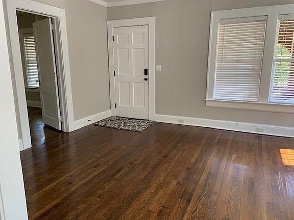 View of front door and first bedroom (to the left)