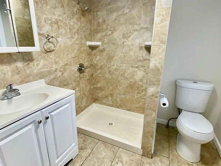 first floor full bathroom with window overlooking back yard