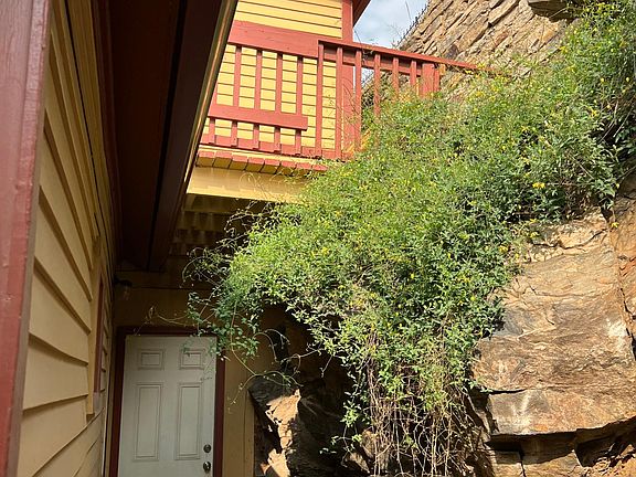 Back of house with small upper deck.