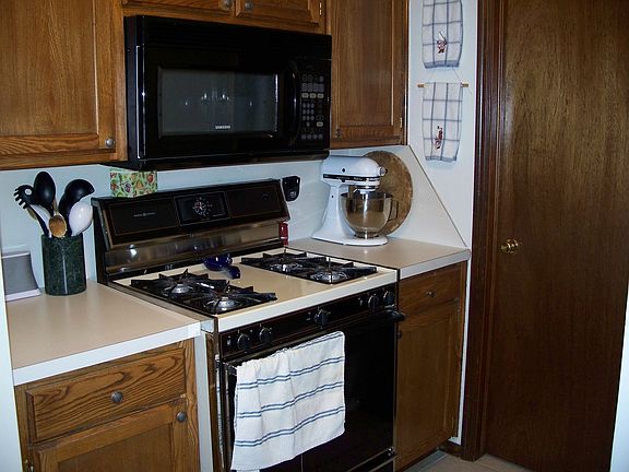 Gas stove, built-in microwave, dishwasher, fridge stays with home.