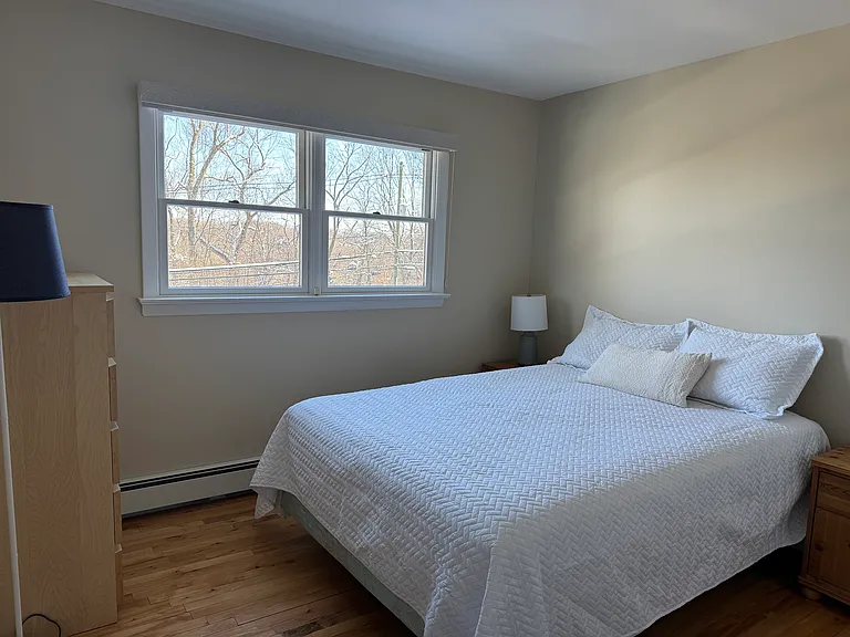 This bedroom is furnished with a queen sized bed, two night stands, two lamps, one large dresser and one small dresser, one walk in closet. It is 10' x 10' - 100 sq. ft.