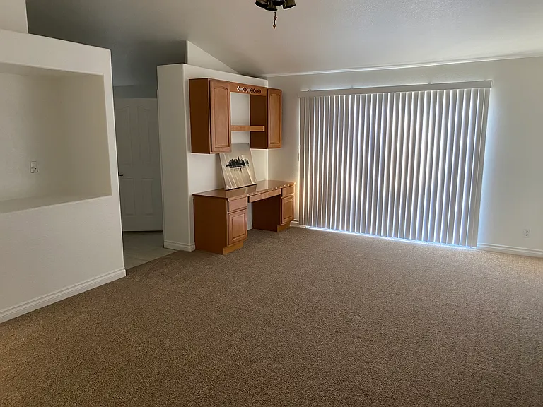 Bedroom #1 - Master with double-door entry, entrance to backyard. Vaulted ceilings, built-in desk and cabinetry, ceiling fan, bathroom entry.