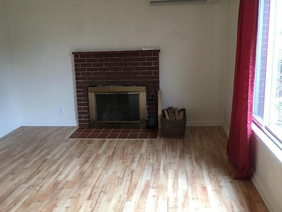 Come on in! Large living room with a fireplace.