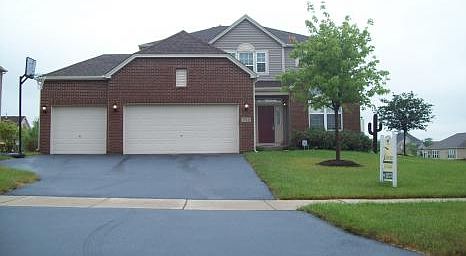 Three car garage and newly sealed driveway.