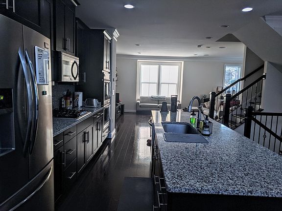 Open concept floor plan, kitchen looking into living area