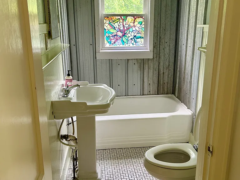 Bathroom with new light fixture and newly re-porcalained tub.