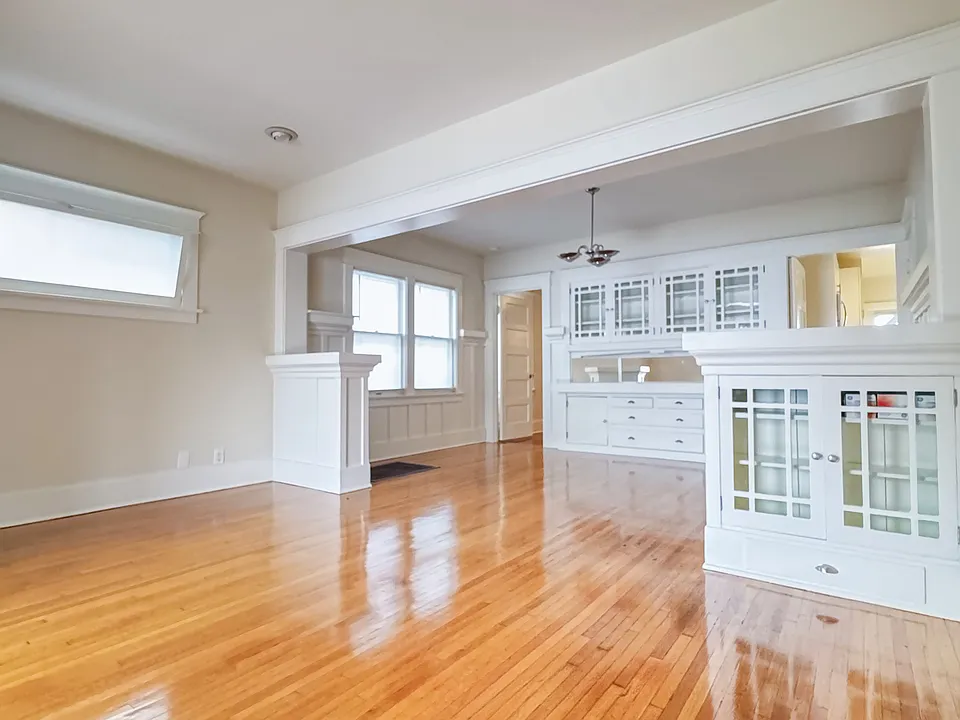Living Room/Dining room separated by built-in cabinets.