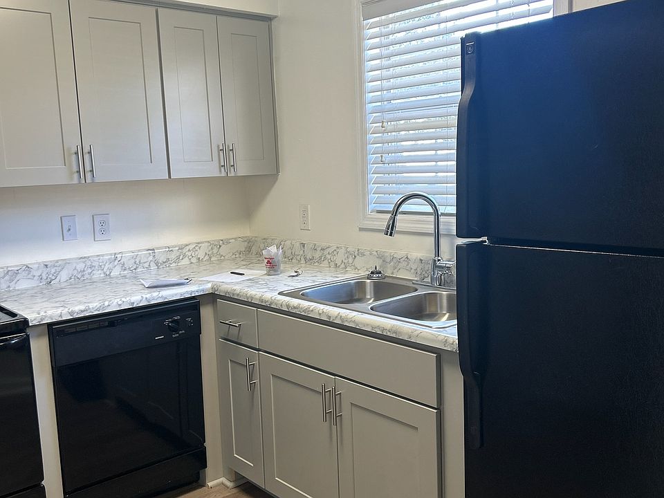 grey, soft close cabinets with black appliances