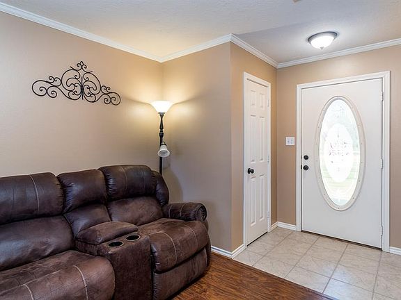 Entry open to the den that features recent laminate wood floors.