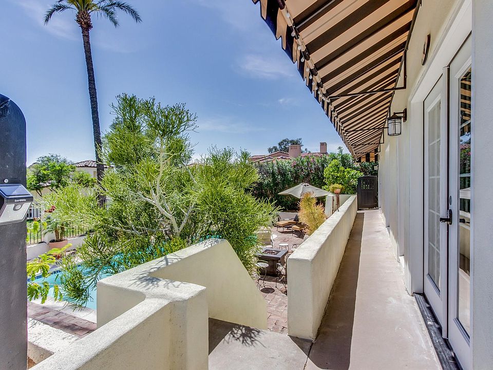 Balcony overlooking pool and front door entrance.