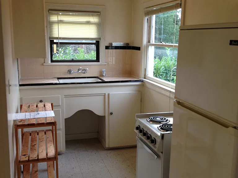 Small galley kitchen with range and refrigerator