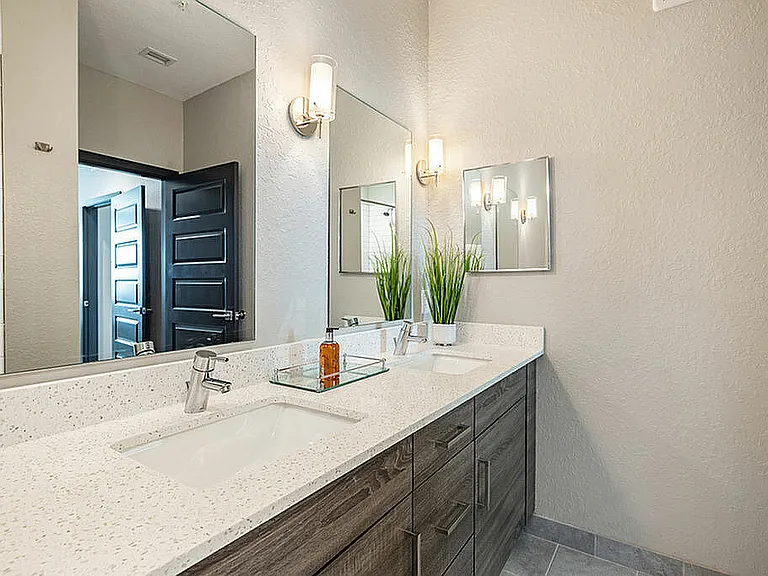 Experience luxury in this beautifully designed bathroom, featuring contemporary double vanities.