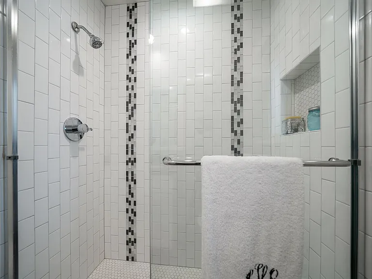 Unit 9 studio tall white subway tile shower with niche & accent gray mosaic tile