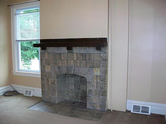 Bedroom with decorative fireplace