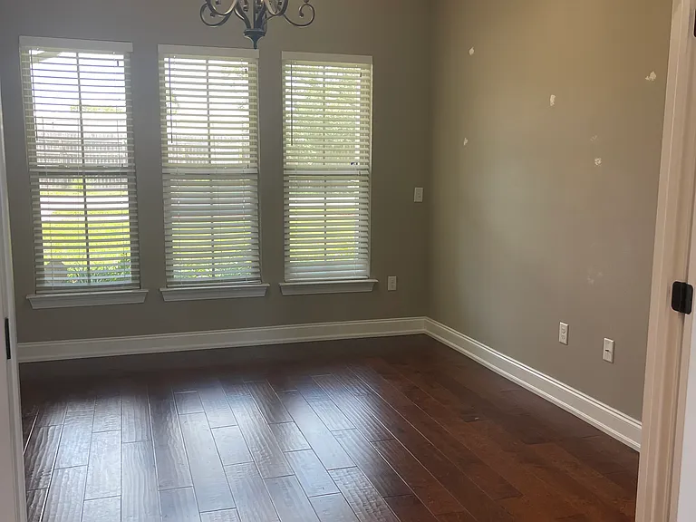 Flex space off the main living room looking out to the front lawn. Double french doors