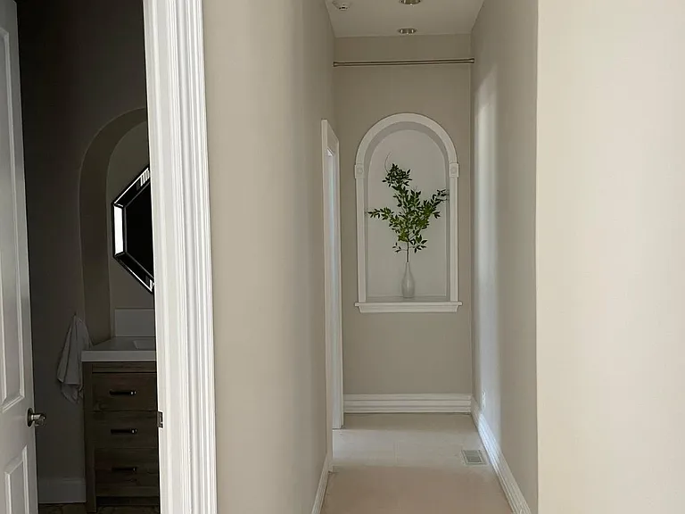 First floor guest half bath and hall to bedroom/playroom